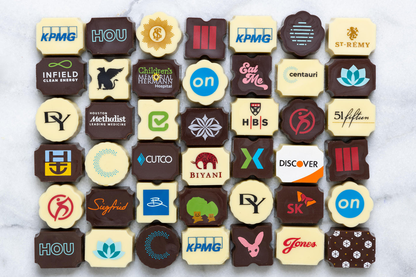 custom chocolate bonbons with various company logos and designs.