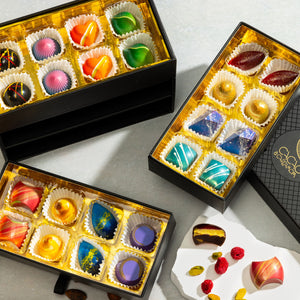 Three boxes of colorful chocolate bonbons