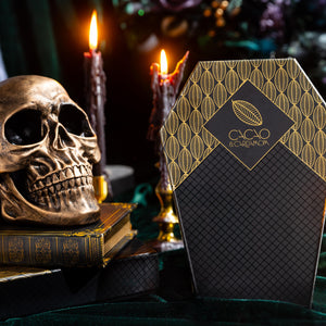 Death by Chocolate Coffin Box 10-piece featuring handcrafted artisan chocolates in a Halloween-themed coffin gift box by Cacao & Cardamom.