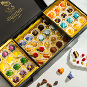 Open Deluxe Chocolate Gift Box displaying handcrafted gourmet chocolates.