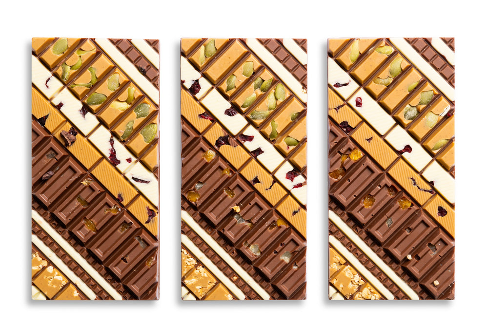Close-up of the Harvest Crunch Artisan Bar highlighting handcrafted chocolate and crunchy toppings.