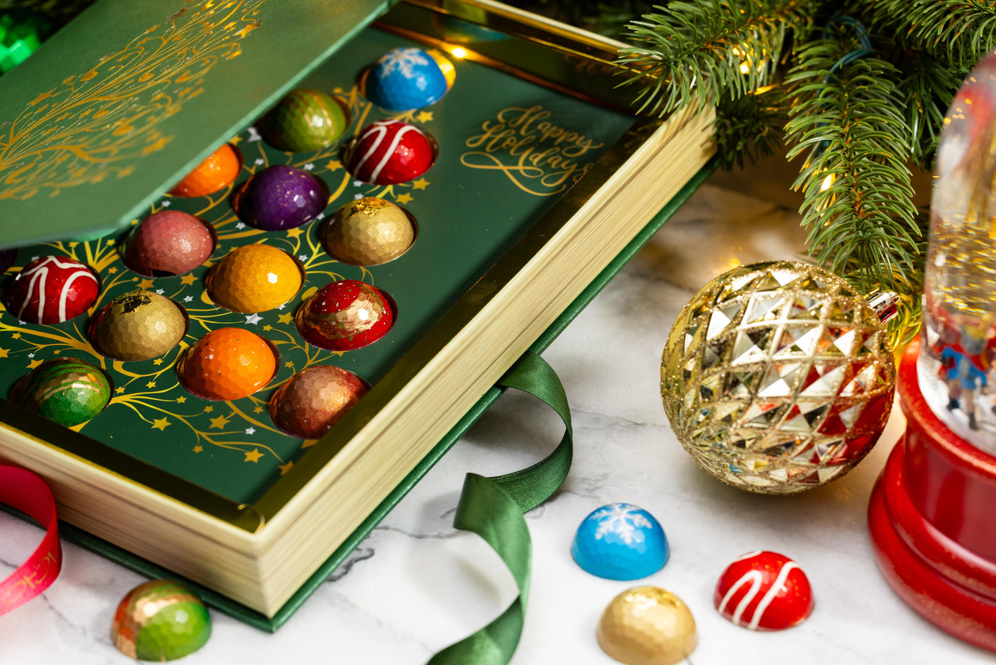 Interior of the Holiday Chocolate Gourmet Gift Box 16-piece revealing handcrafted artisan chocolates arranged inside.