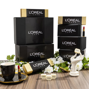 L'Oreal boxes on a wooden table with decorative items