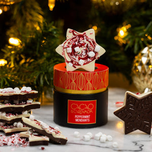 Peppermint Snowflake Mendiant featuring handcrafted artisan chocolate topped with festive peppermint and holiday decorations by Cacao & Cardamom.