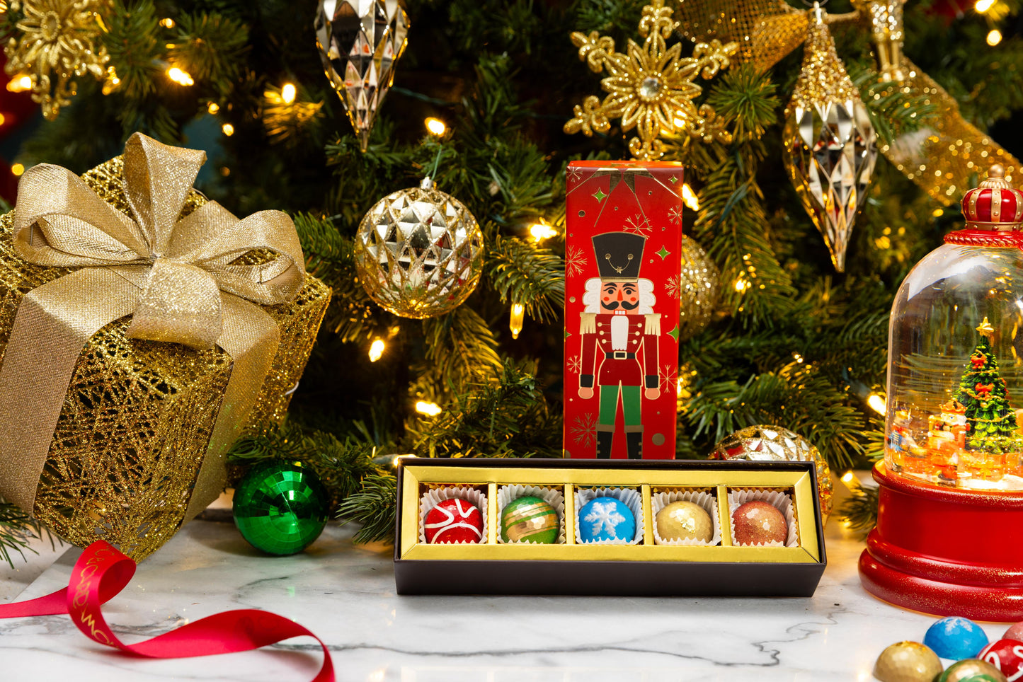 Open Petite Nutcracker 5-piece gift box displaying handcrafted gourmet chocolates.