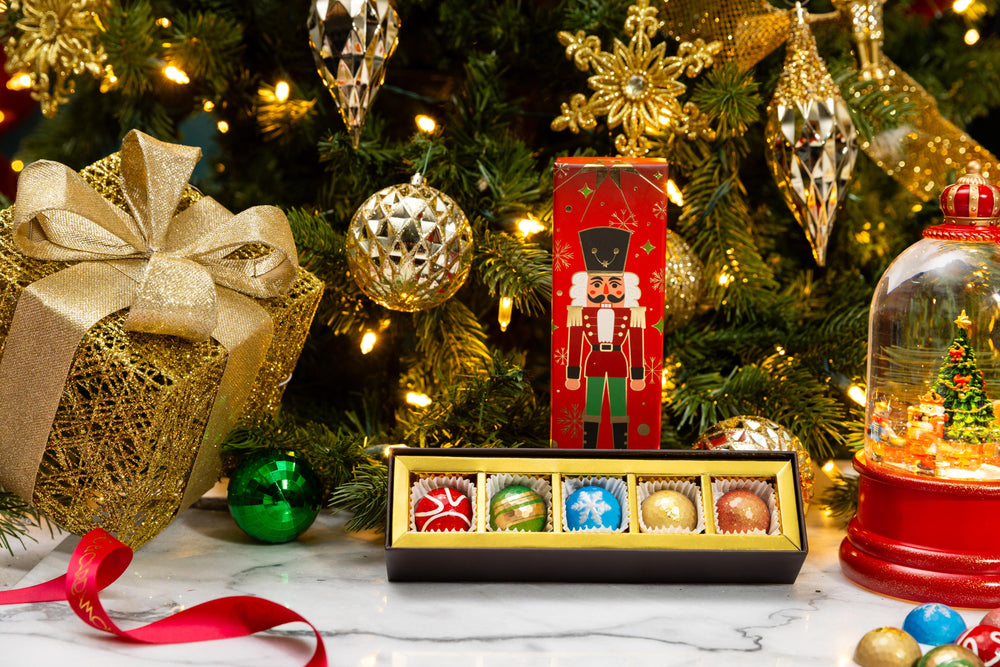 Open Petite Nutcracker 5-piece gift box displaying handcrafted gourmet chocolates.