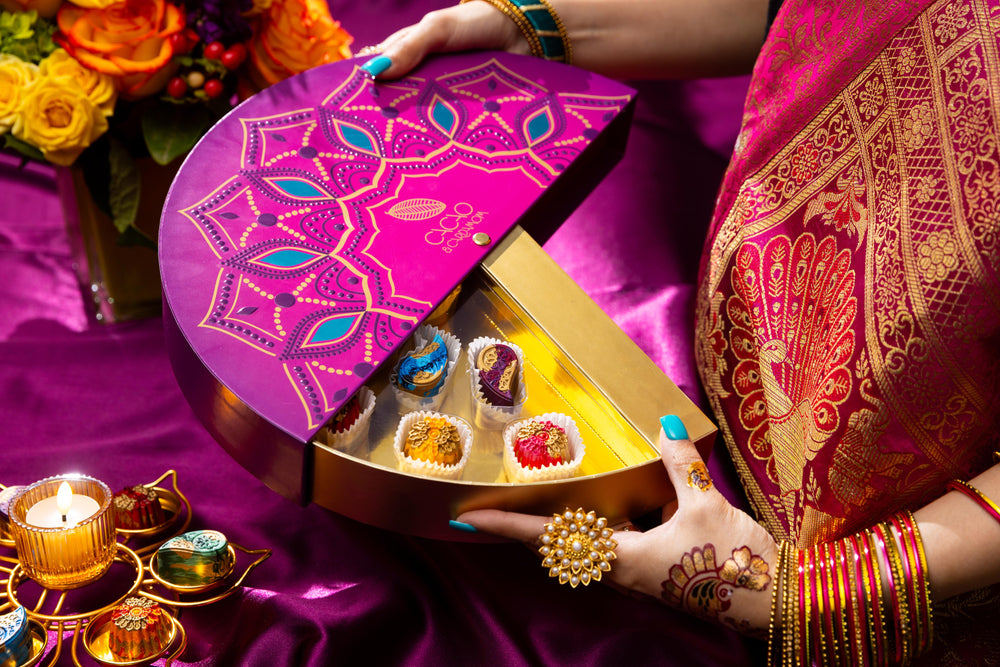 Individual handcrafted artisan chocolates from the Rangoli Gift Box 14-piece collection featuring vibrant Diwali-inspired designs.