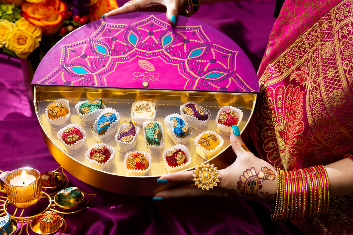 Open Rangoli Gift Box 14-piece displaying handcrafted artisan chocolates.