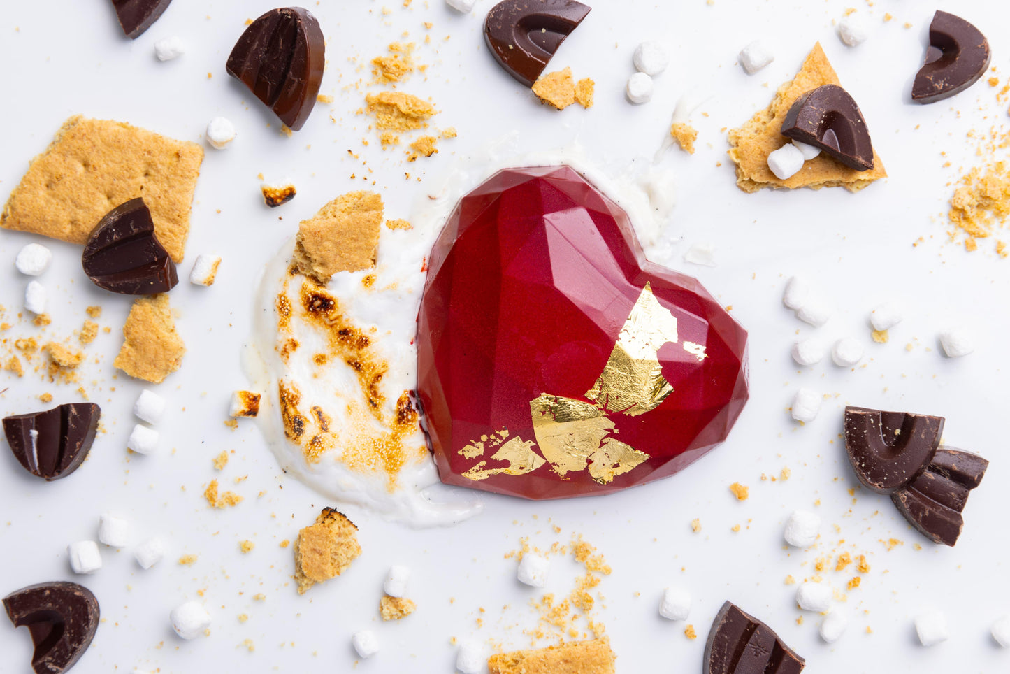 A heart-shaped, red chocolate bar with marshmallow and graham crackers