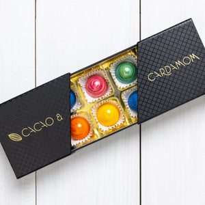 A box of assorted chocolates from the Summer Collection, with visible colorful candies and a label that reads 'COCO & CARDAMOM'.