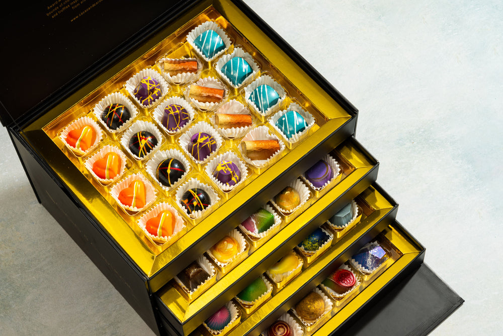 Close-up of handcrafted artisan bonbons from the Ultimate Bon-Bon Collection 80-piece gift box.