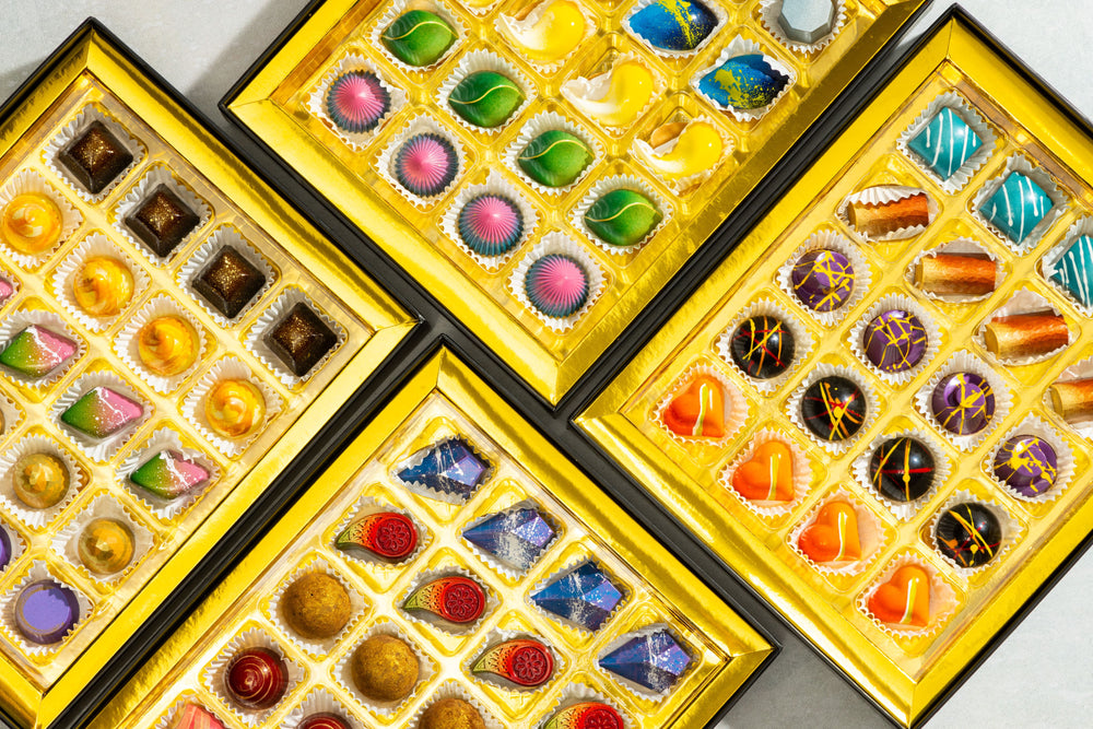 Top view of the Ultimate Bon-Bon Collection 80-piece showcasing handcrafted artisan bonbons arranged in a luxury chocolate gift box by Cacao & Cardamom.