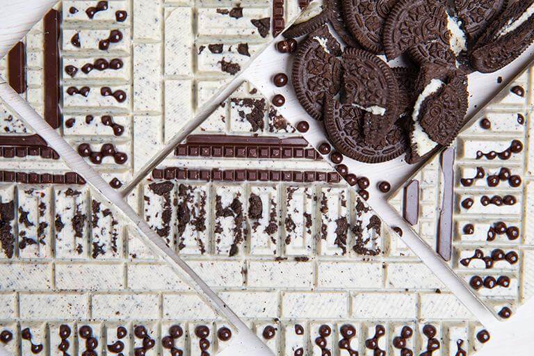 Cookies & Cream Artisan Bar featuring handcrafted premium chocolate with crunchy cookie pieces.