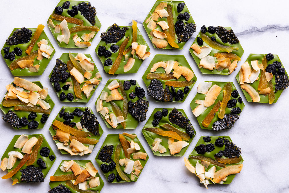 Open Matcha Mendiants displaying handcrafted gourmet chocolate discs.
